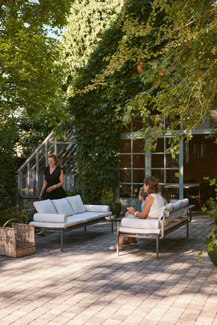 View of the Sol+Luna outdoor loungers transformed into sofa seating with soft Marble-colored cushions, capturing a cozy outdoor atmosphere.