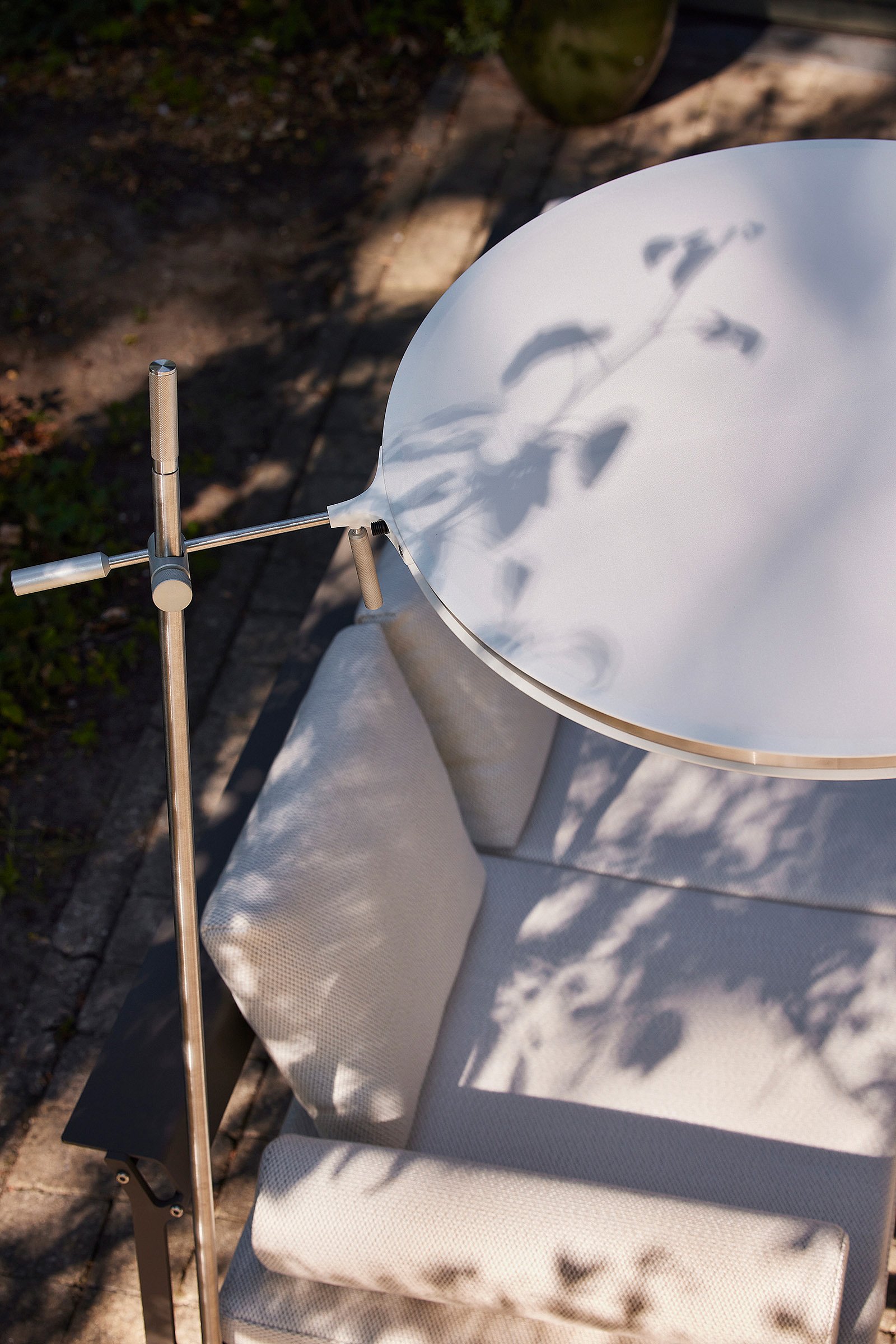 Close-up of one or two Sol+Luna loungers showing their sculptural frame and mesh fabric, set up for relaxing and sunbathing in the garden.