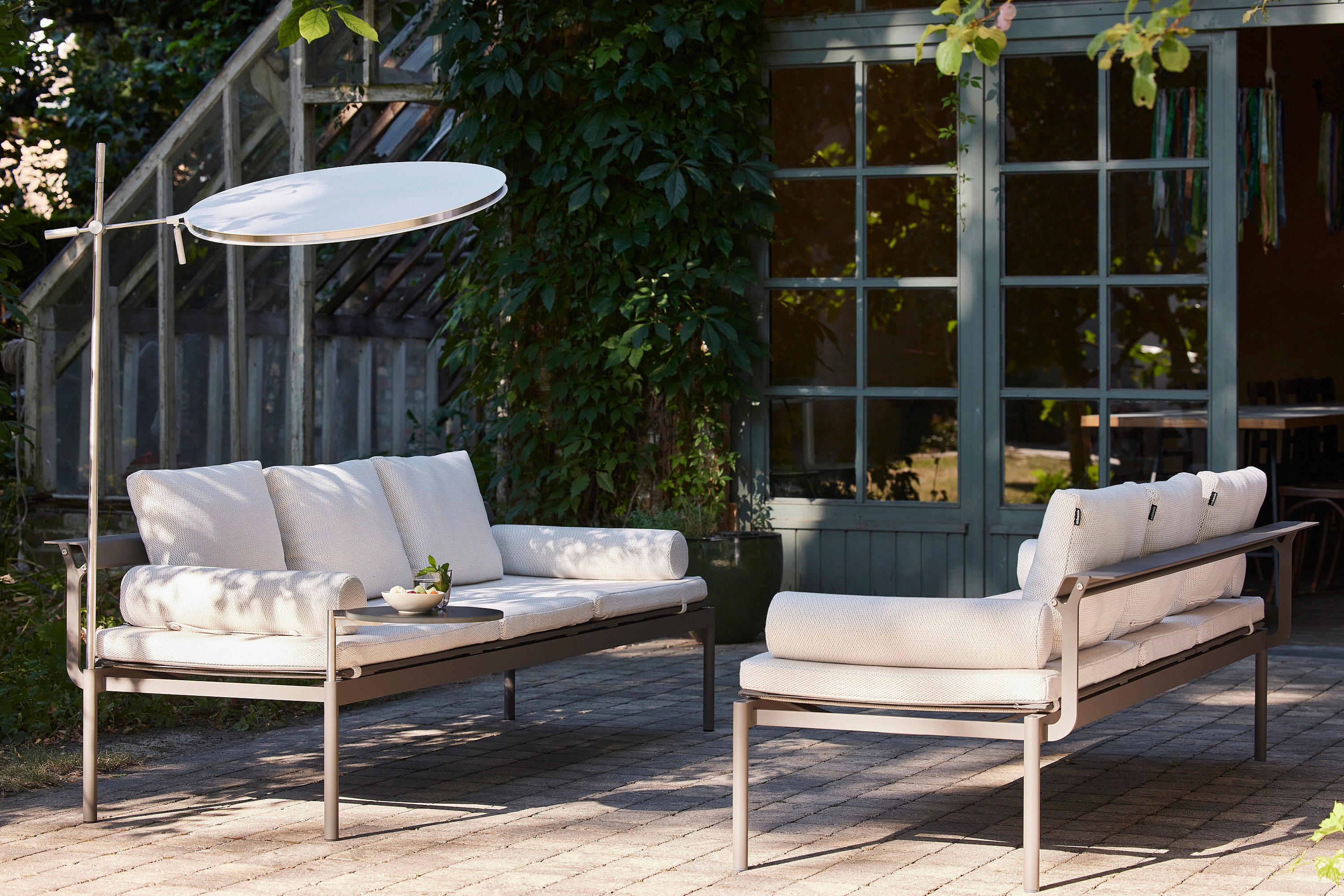 Lifestyle shot focusing on the Sol+Luna loungers with cushions and optional accessories, inviting a sense of comfort and leisure.