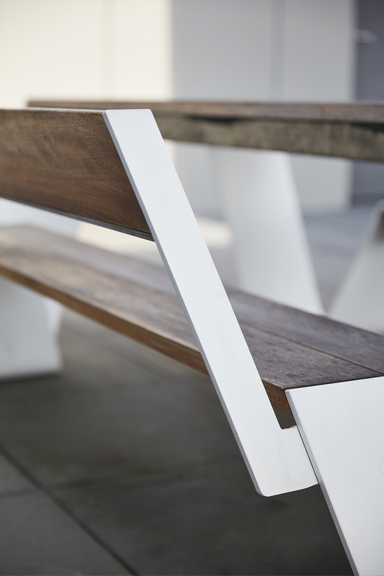 Close-up shot of Extremis outdoor furniture placed along a paved urban seating area.