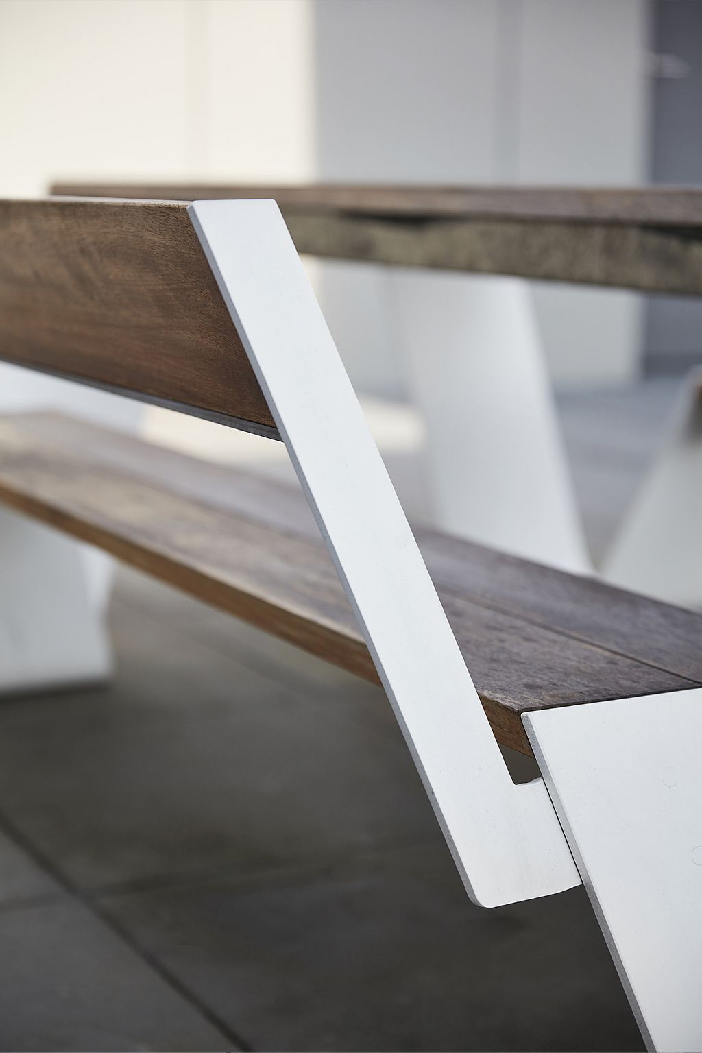 Close-up shot of Extremis outdoor furniture placed along a paved urban seating area.