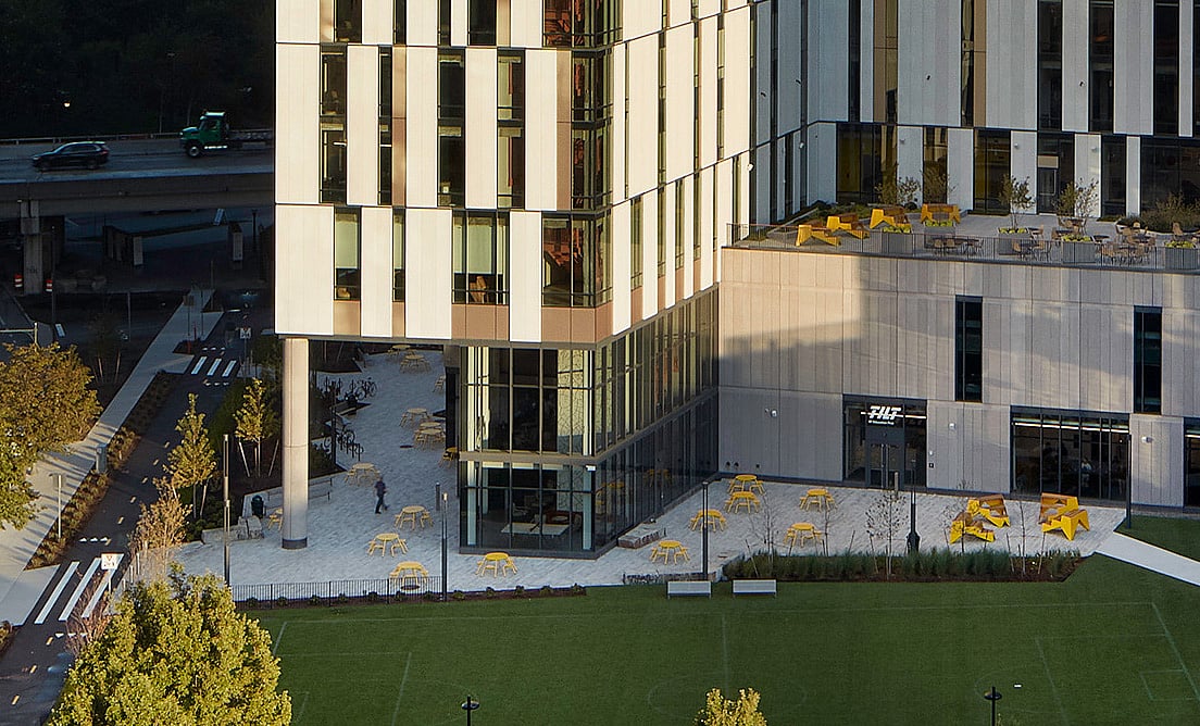 Wide exterior view of Hult House in Boston with a modern patio featuring Extremis outdoor furniture.