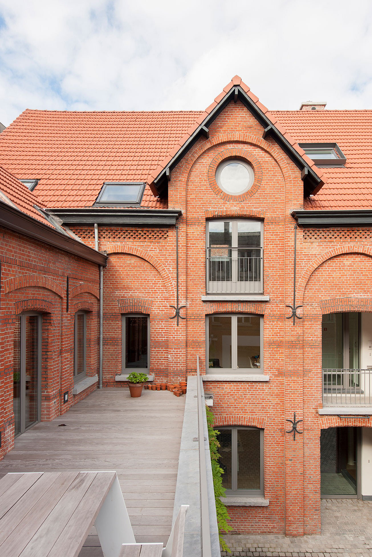   Der gemeinsame Innenhof der ehemaligen Zuckerfabrik mit Bäumen, Pflanzen und Sitzgelegenheiten verbindet die Loftwohnungen und Büros.