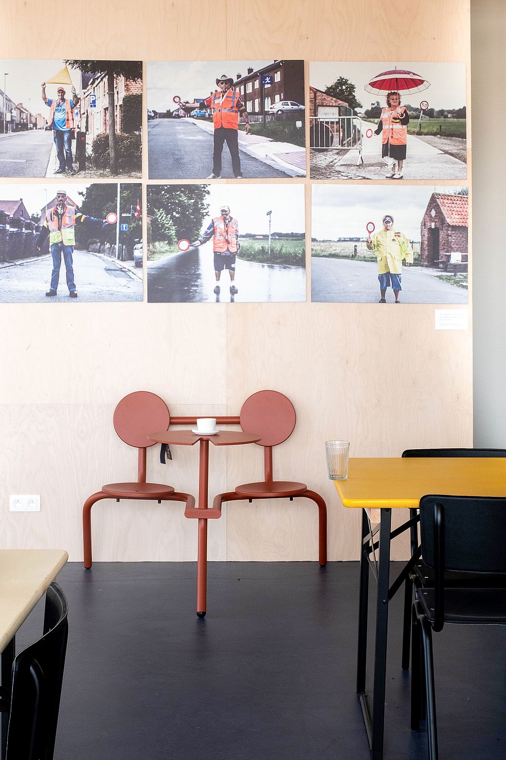 Compact Bistroo standing table placed near the walkway, offering a spot to pause for a drink and watch passers-by.