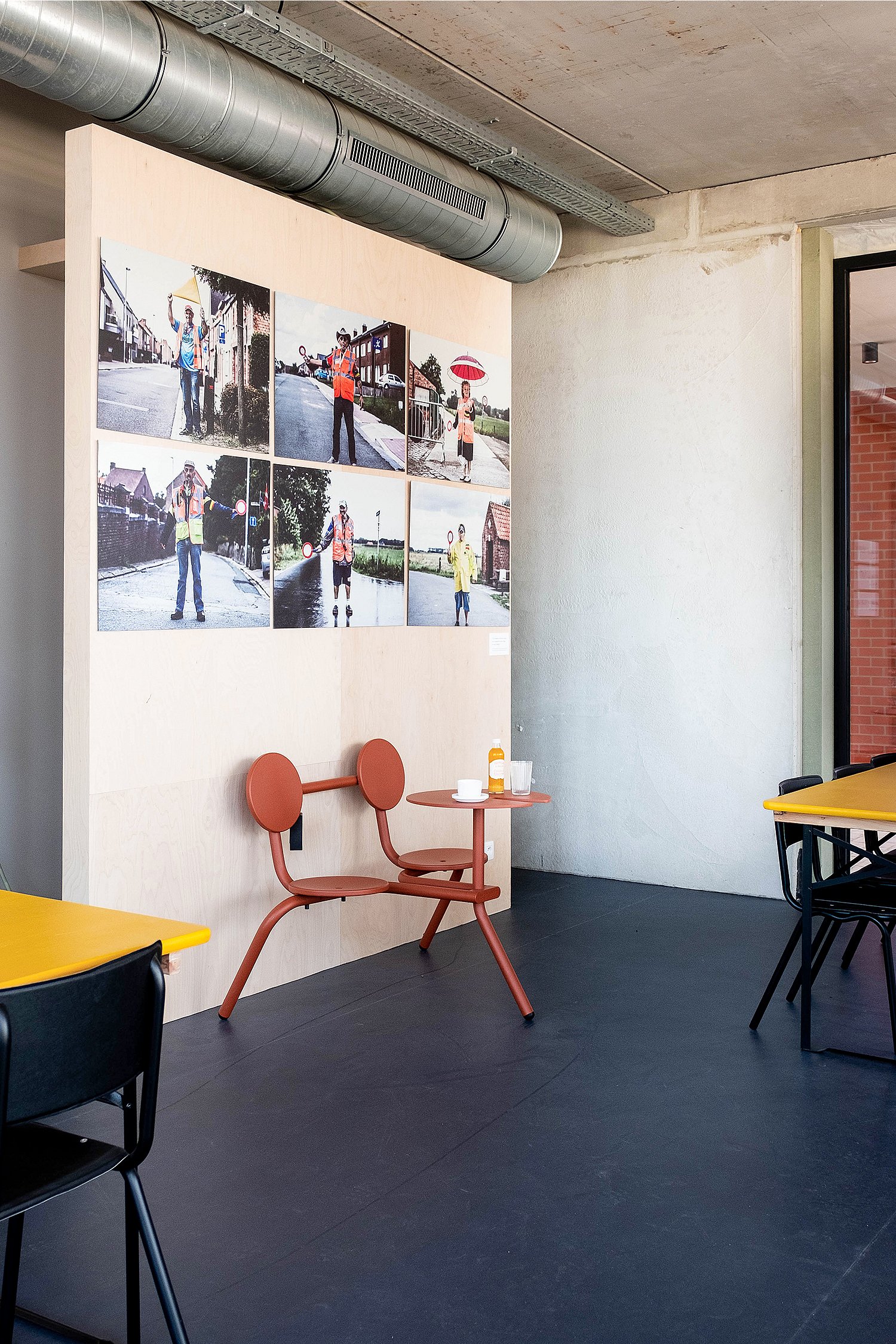 Compact Bistroo standing table placed near the walkway, offering a spot to pause for a drink and watch passers-by.