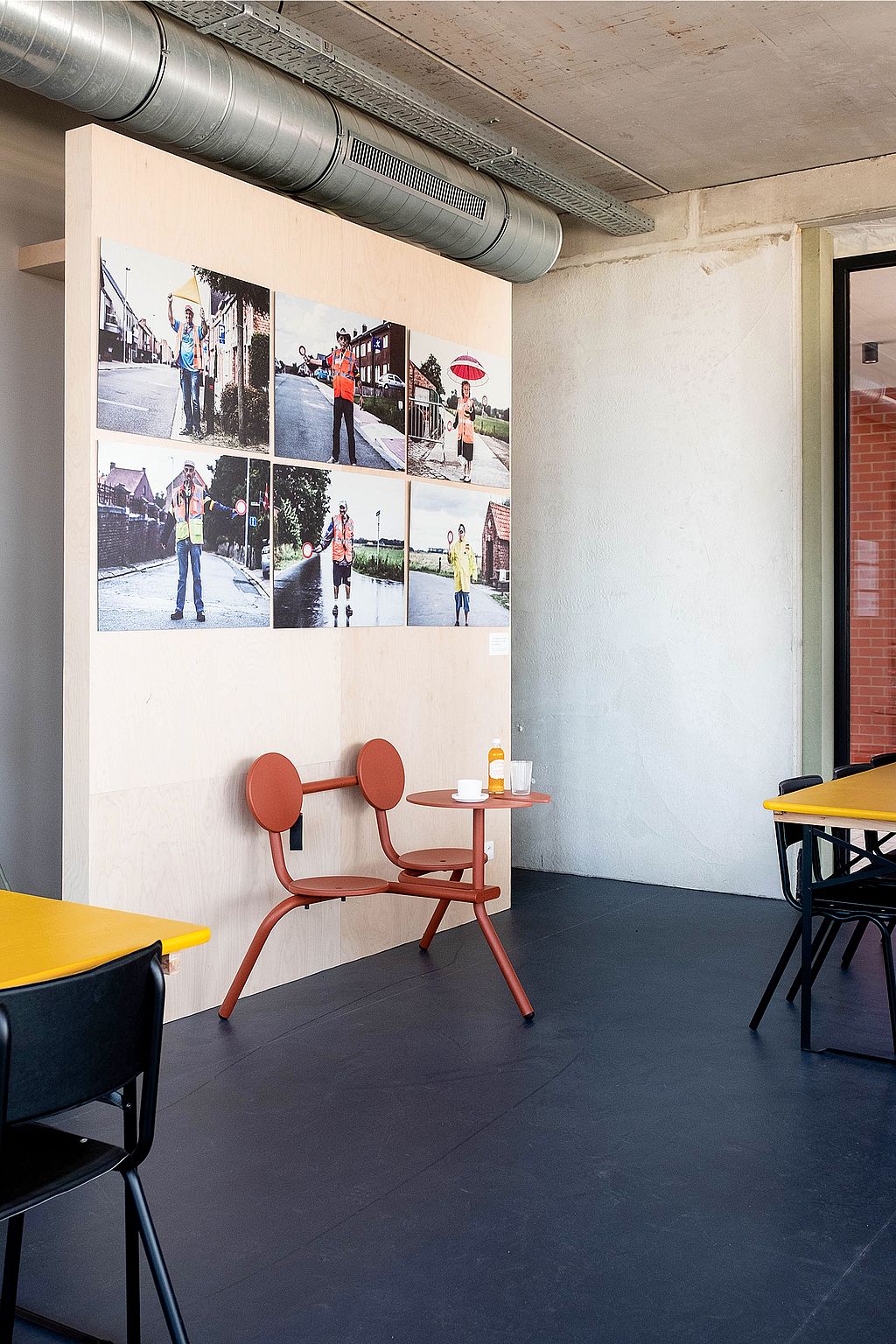 Compact Bistroo standing table placed near the walkway, offering a spot to pause for a drink and watch passers-by.