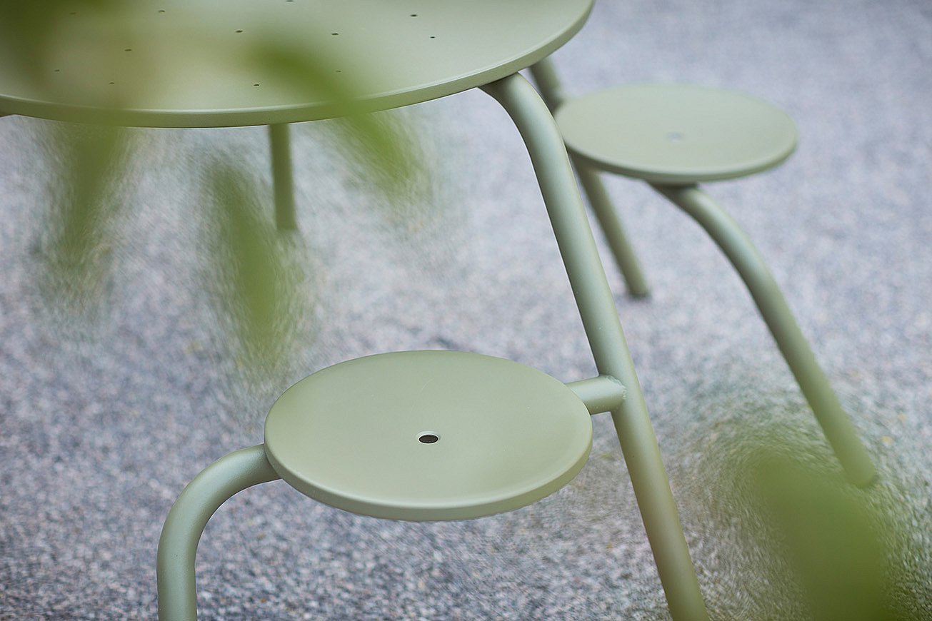 Colorful Virus table in the holiday-house garden, encouraging spontaneous play, conversation, and shared enjoyment.