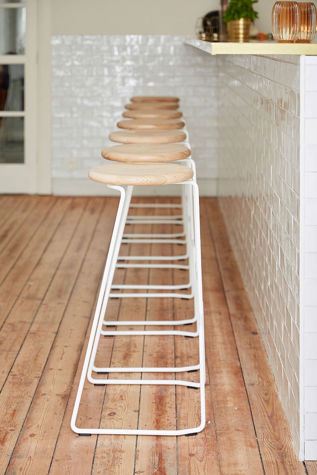 Several Tiki bar stools grouped neatly at the counter in Den Olifant, complementing the classic interior with their minimalist lines.