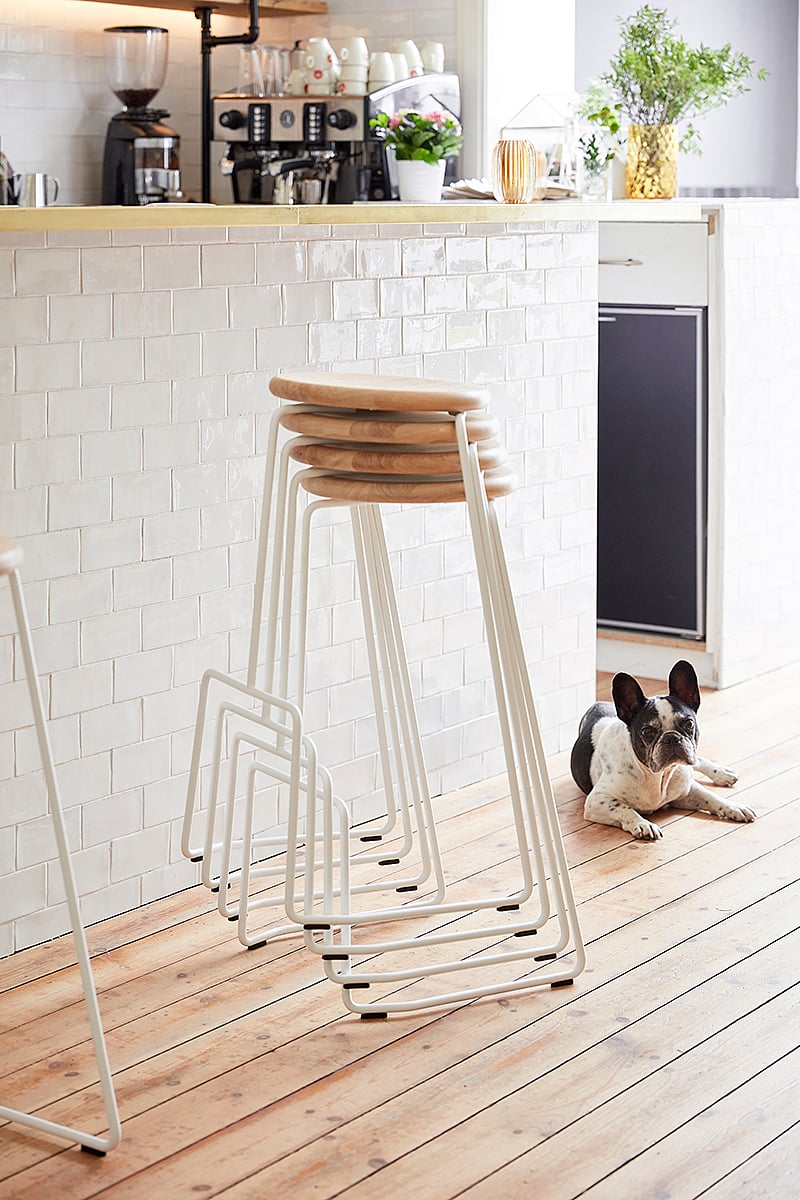 Stacked Tiki bar stools forming a compact vertical tower, highlighting the stools’ lightweight and stackable design.