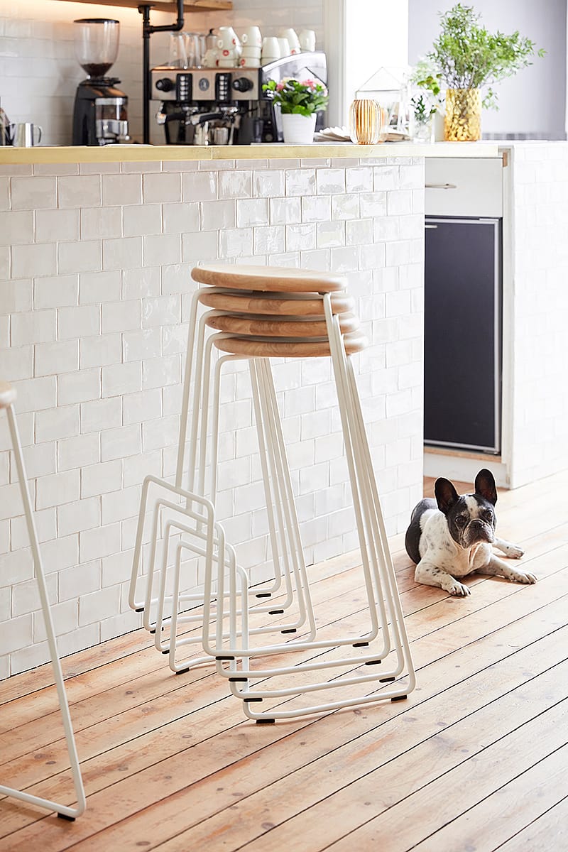 Stacked Tiki bar stools forming a compact vertical tower, highlighting the stools’ lightweight and stackable design.