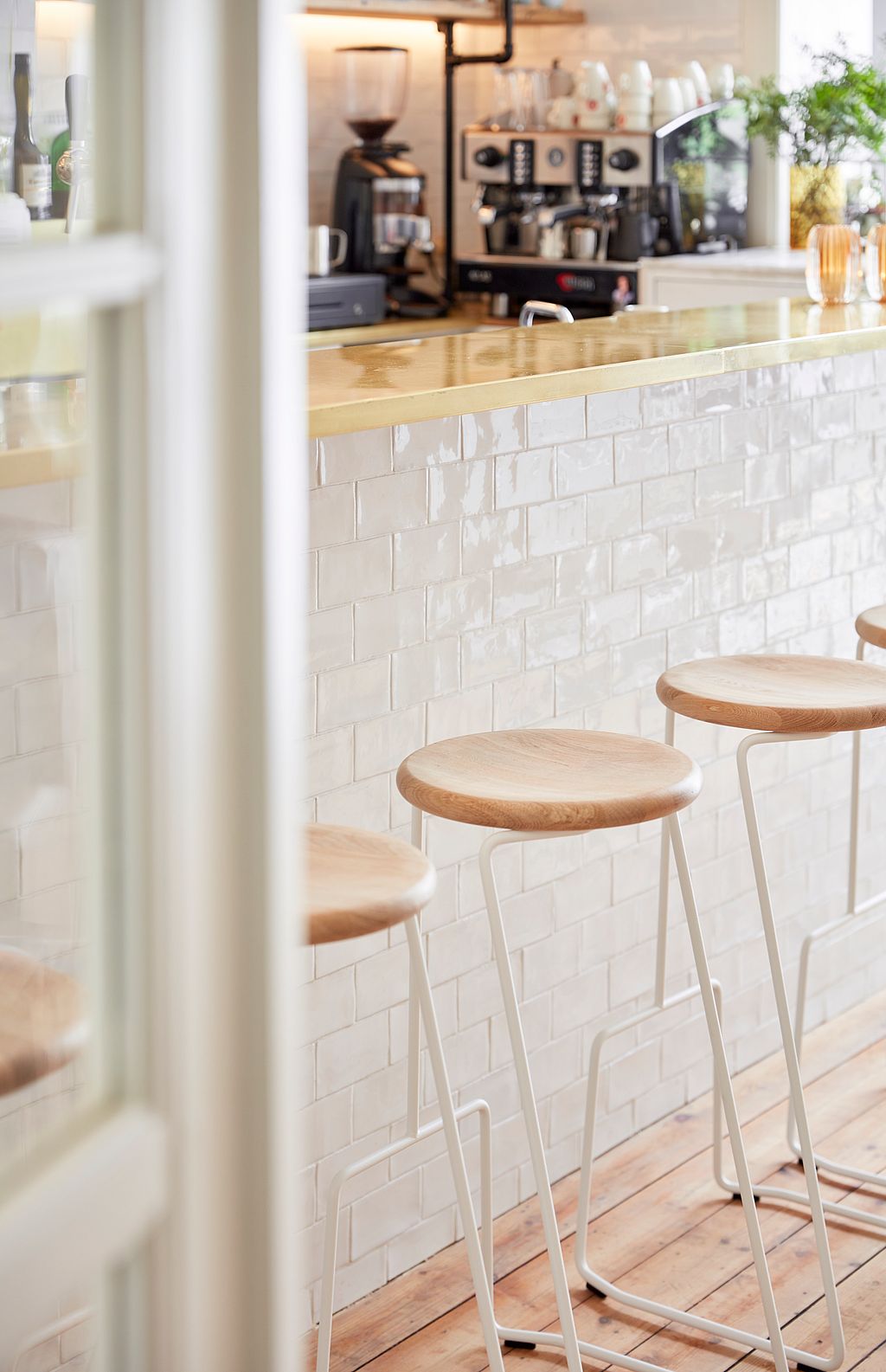 Atmospheric restaurant bar with Tiki stools, hardwood flooring, and preserved historic details that give the space a grand yet welcoming character.