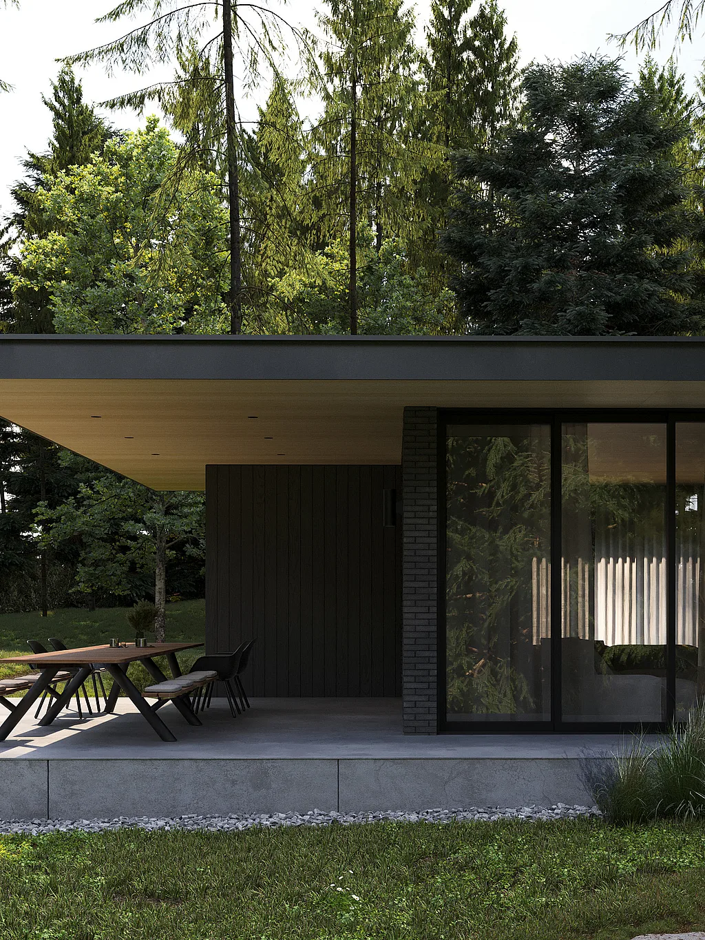 Long Panigiri table with benches and black Captain’s Chairs on a shaded concrete terrace beside a modern dark bungalow surrounded by tall pine trees.