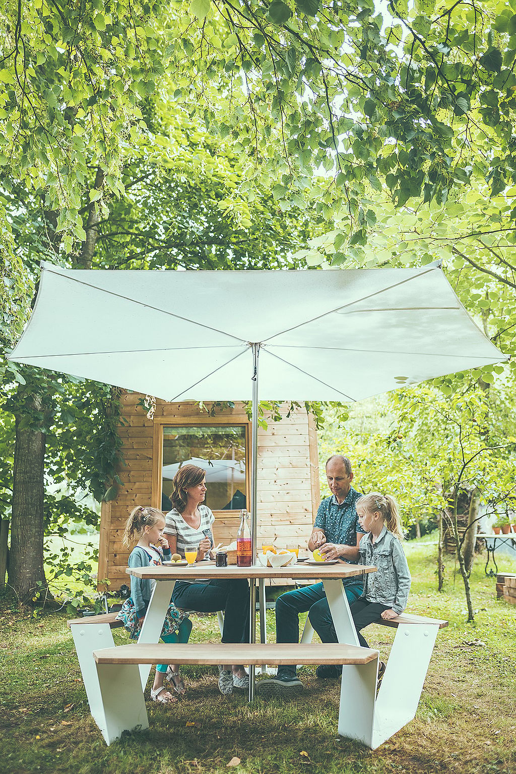 People gathered around the anker for food and drinks accompanied by the children.