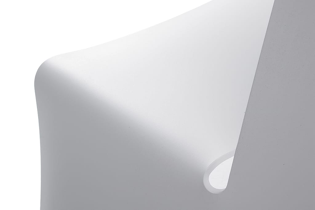 Close-up of a white folded aluminium picnik surface with a soft curved edge and teardrop-shaped cut-out, highlighting the sculptural simplicity of the Picnik design.