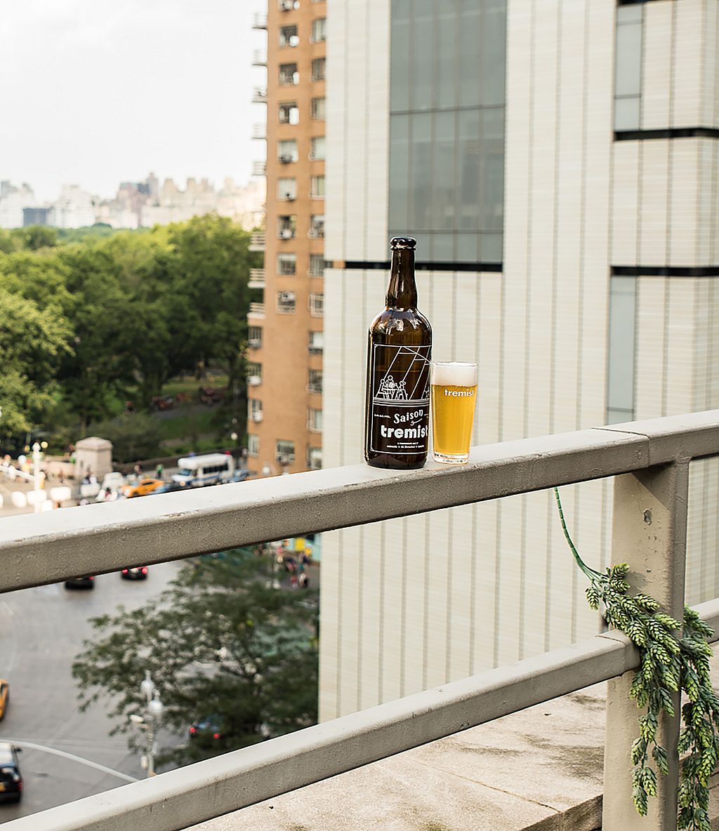 Flasche und Glas Tremist-Bier stehen auf dem Dachvorsprung und bieten einen atemberaubenden Blick über den Central Park und den Kreisverkehr darunter.