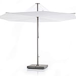 Studio shot of a large white inumbrina parasol with a central metal pole and square weighted base on a plain background.