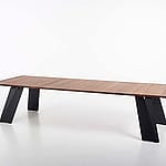 Studio shot of a long rectangular wooden Pontsun table with white angled legs on a plain white background.