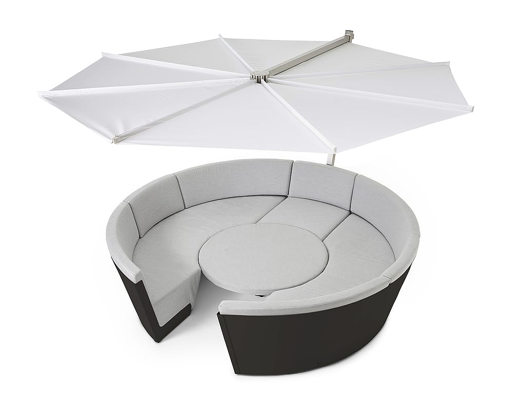 Studio shot of a round white lounge seat with beige cushions, a central round table, and a large white parasol above.