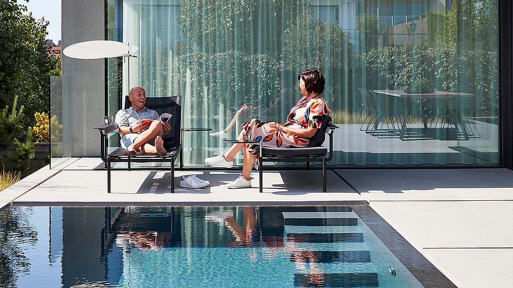 Sol+Luna shown in a real-life outdoor reference setting, illustrating the collection in a garden, terrace, or poolside environment.