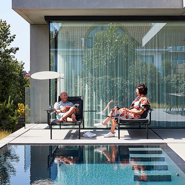 Sol+Luna shown in a real-life outdoor reference setting, illustrating the collection in a garden, terrace, or poolside environment.