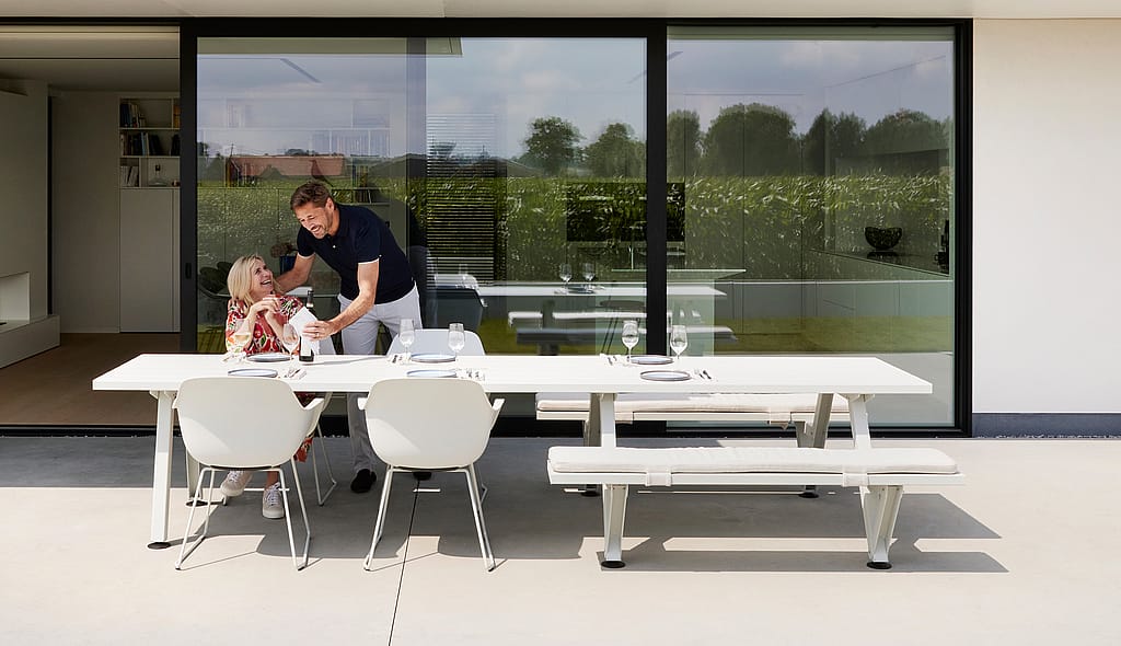 Captain’s Chair shown as an all-season outdoor seat with a water-draining shell and fitted cushion that follows the curves of the chair.
