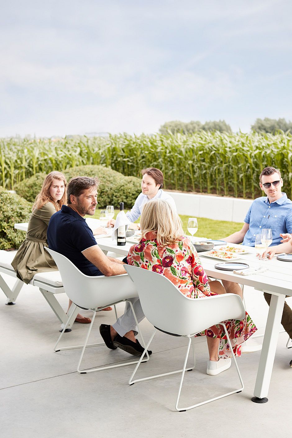 Captain’s Chair shown as an all-season outdoor seat with a water-draining shell and fitted cushion that follows the curves of the chair.