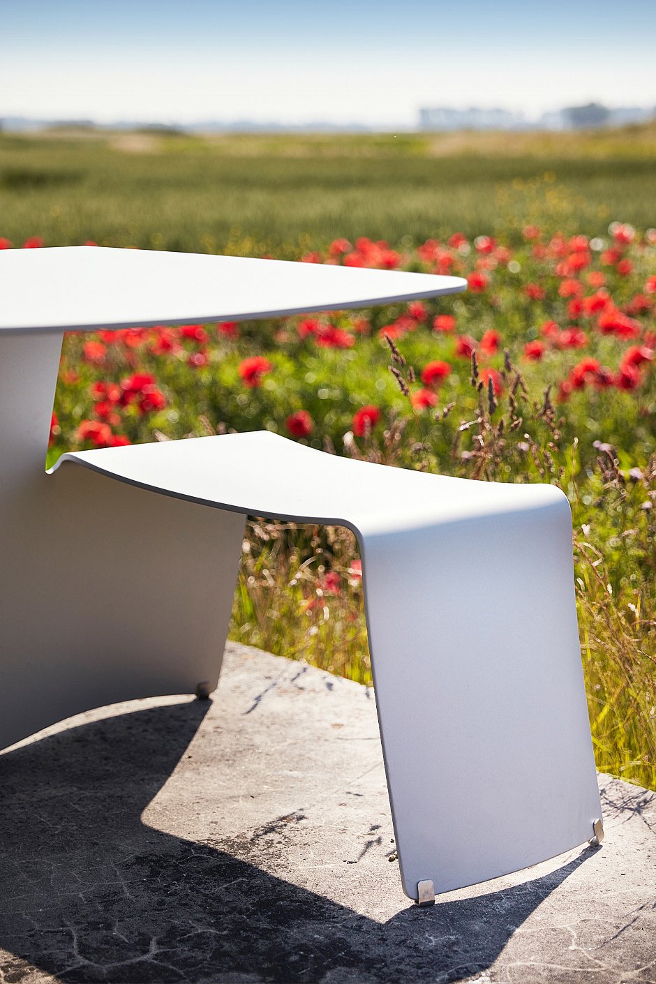 Outdoor shot of a red picnik table in the peaceful countryside.