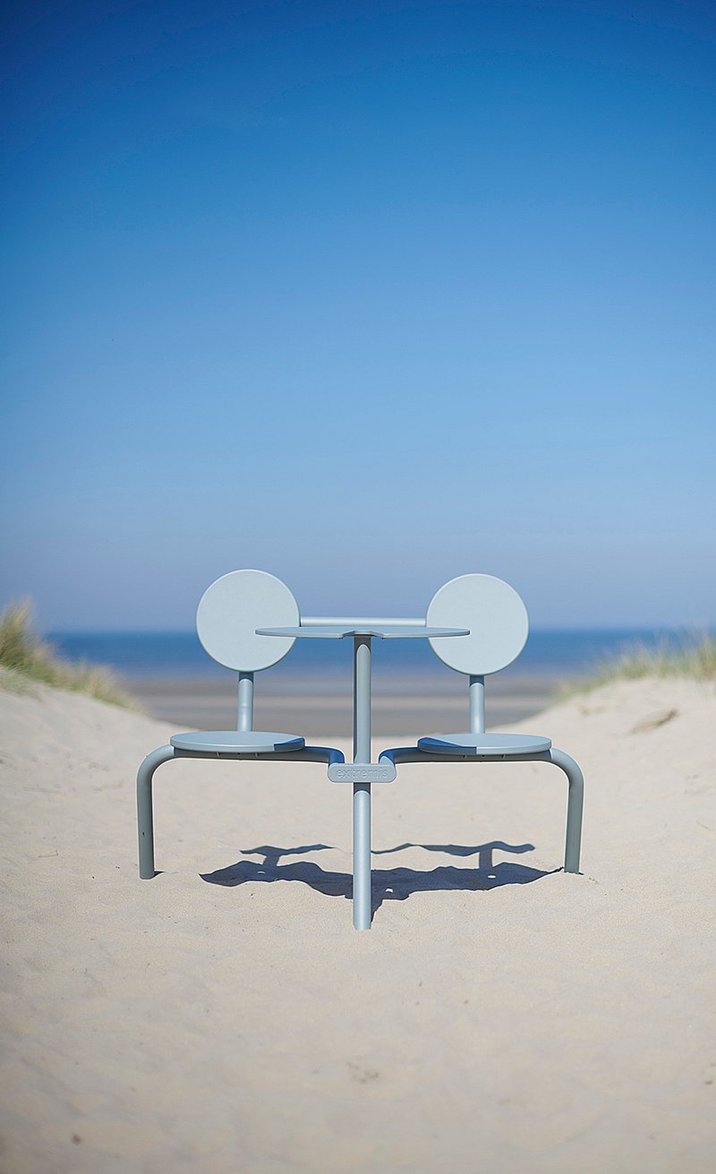 Verdigris Bistroo table and two seats placed in the sand dunes facing the sea
