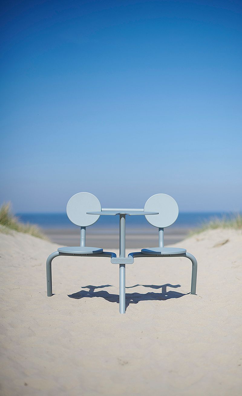 Verdigris Bistroo table and two seats placed in the sand dunes facing the sea