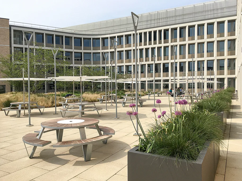 Pantagruel picnic tables with Inumbrina parasols in the Cambridge Assessment courtyard