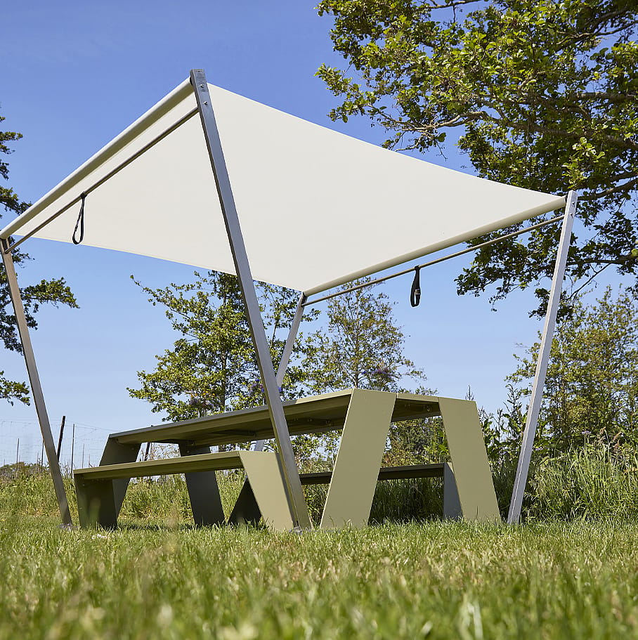 Green Hopper picnic table with white Hopper shade in a sunny garden