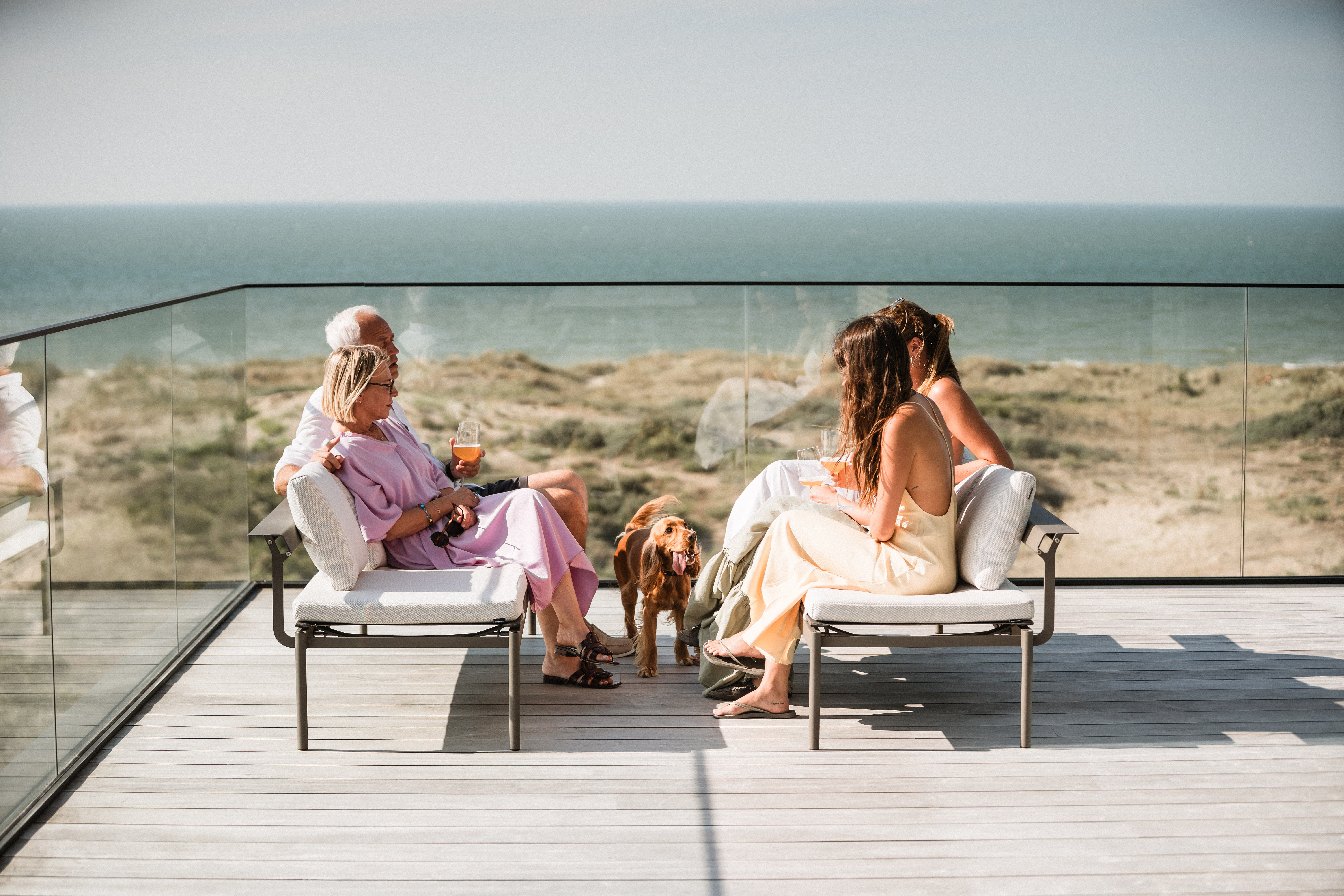 Family relaxing on Sol+Luna lounge seats overlooking the North Sea