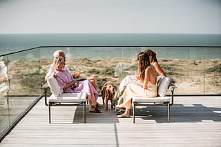 Family relaxing on Sol+Luna lounge seats overlooking the North Sea