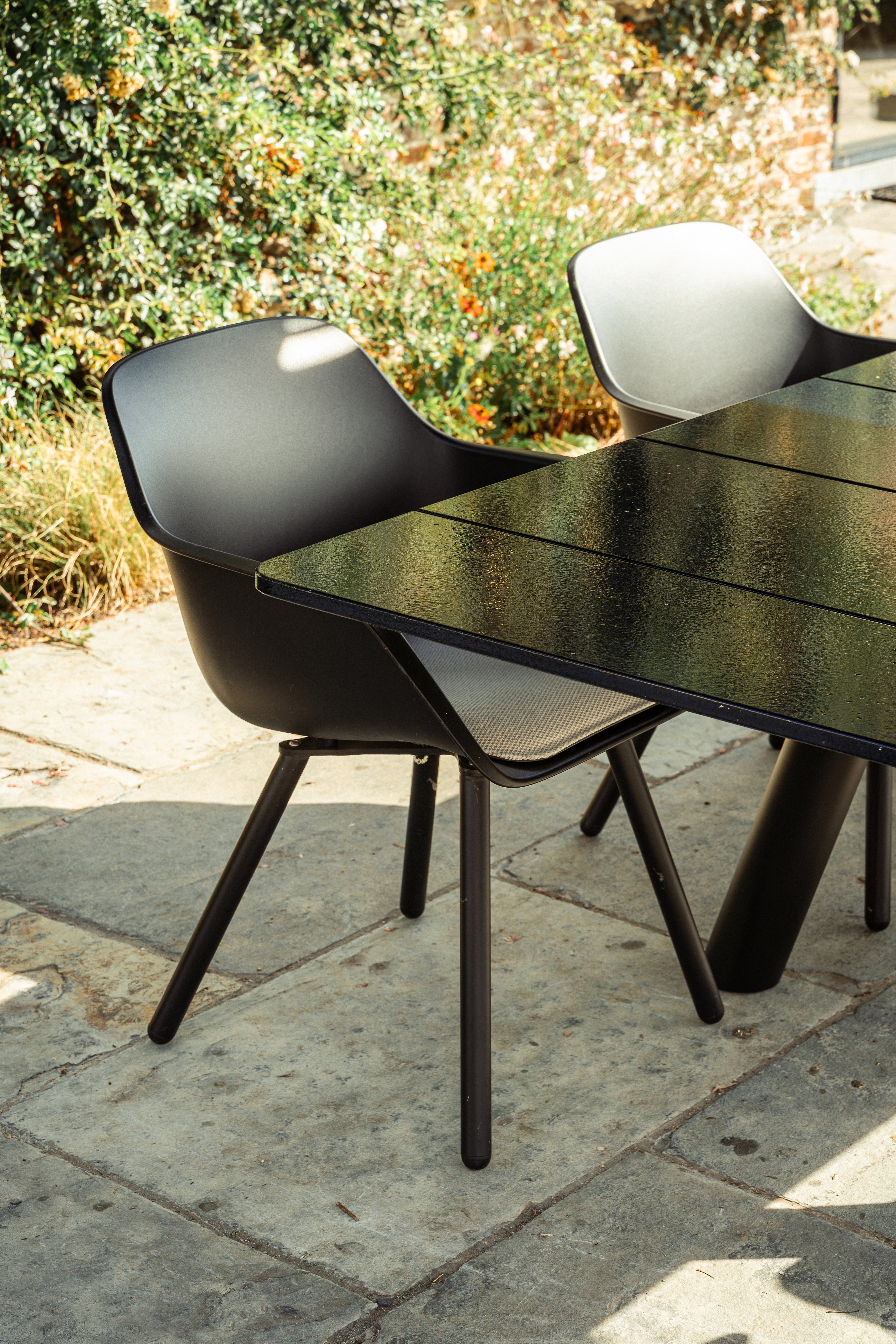 Black Captain’s Pipe Chairs around a Panigiri Lava table in the garden