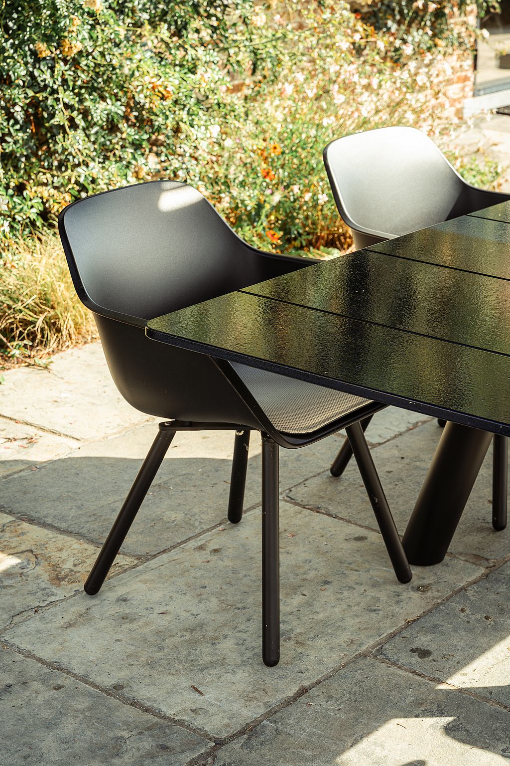 Black Captain’s Pipe Chairs around a Panigiri Lava table in the garden