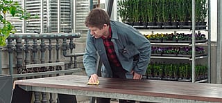 Mann ölt das Holz des Trichters ein