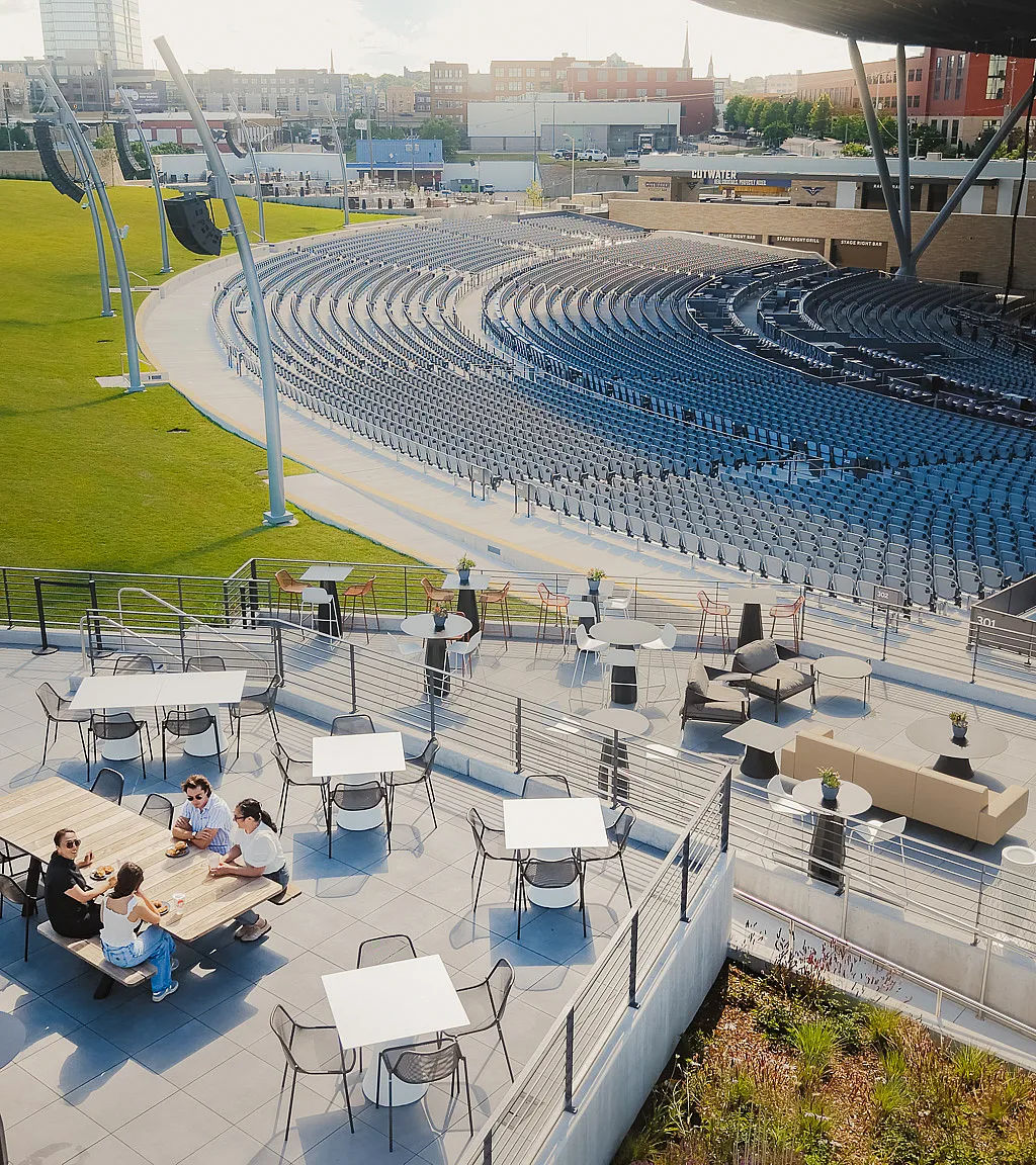 Group of 4 people sitting in amphitheater's VIP Pavilion at an outdoor event space