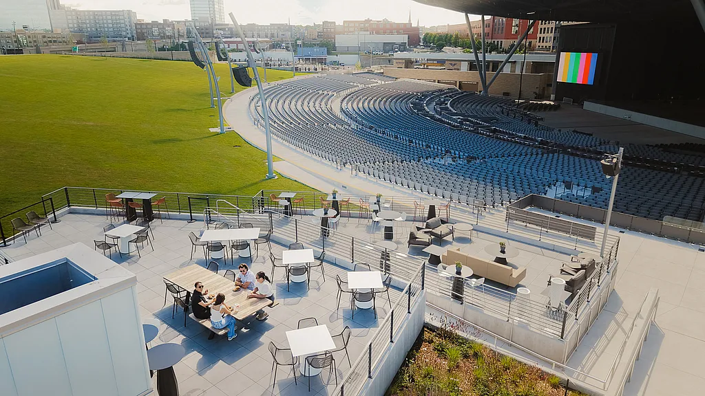 Group of 4 people sitting in amphitheater's VIP Pavilion at an outdoor event space