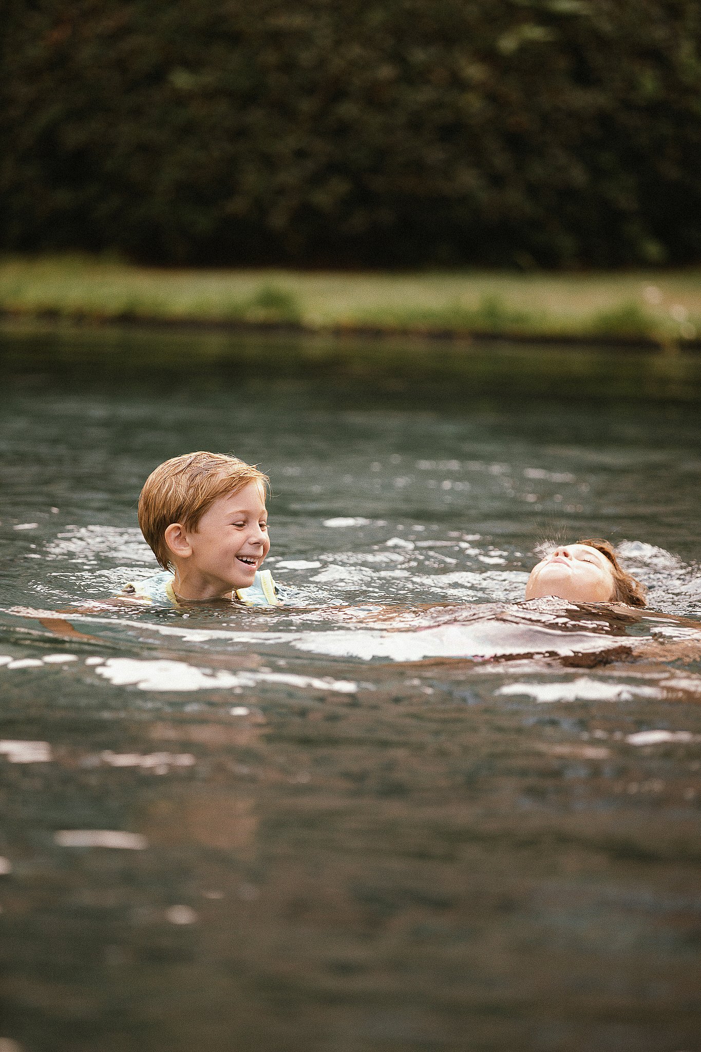 Children swimming in the pool beside the farmhouse garden