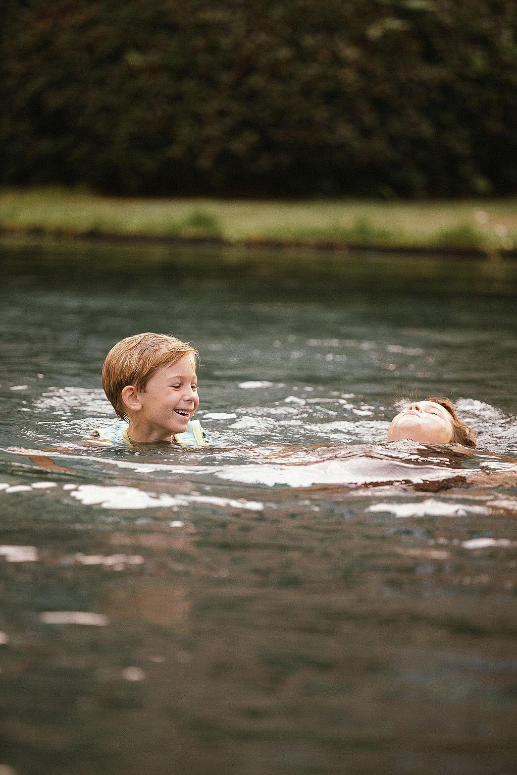 Children swimming in the pool beside the farmhouse garden