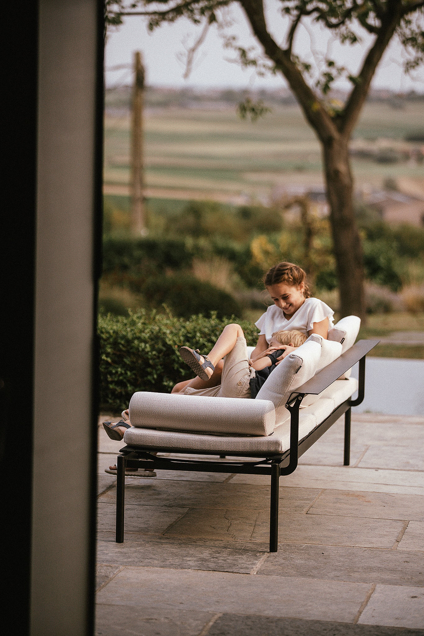 Two children playing together on a Sol+Luna lounger