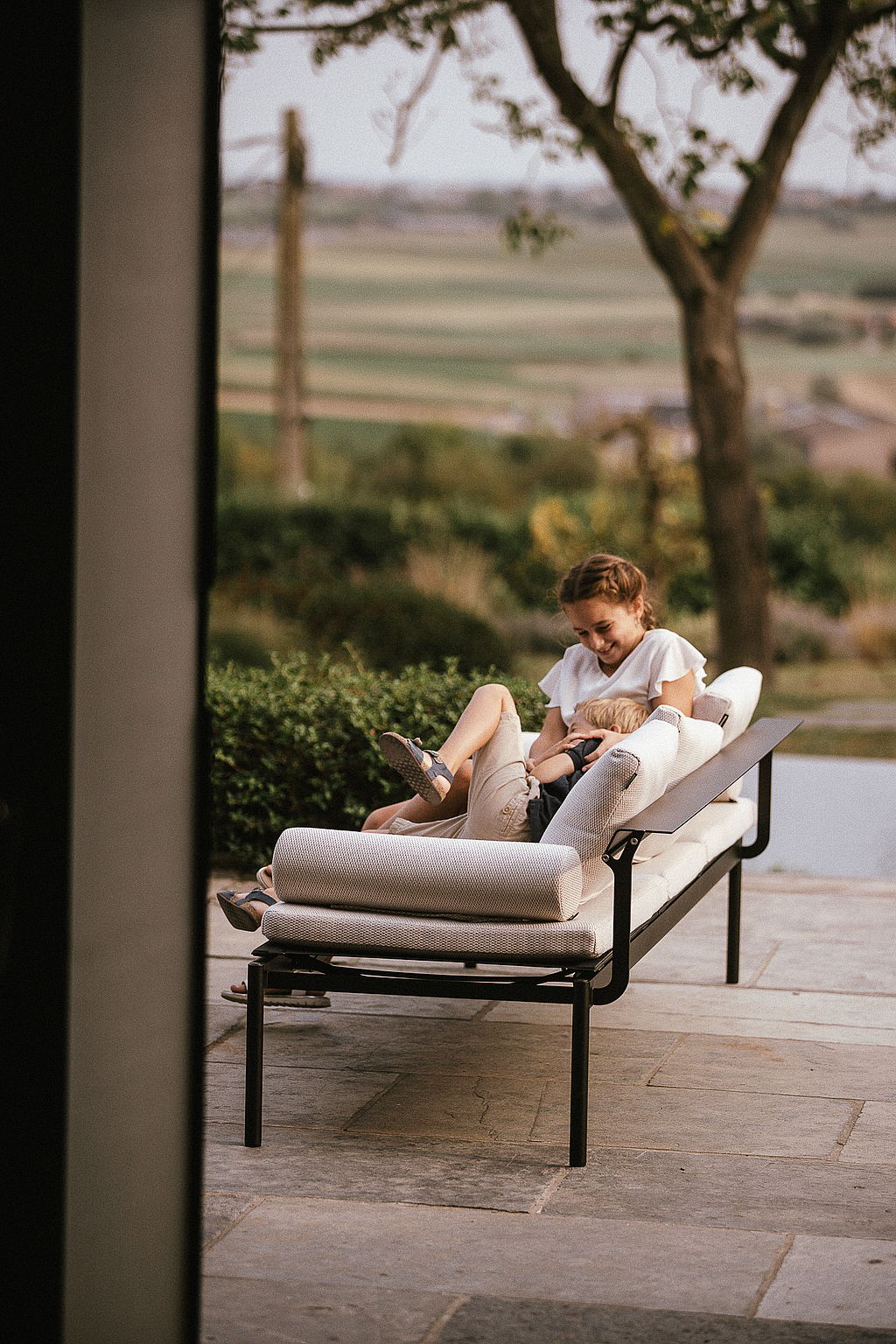 Two children playing together on a Sol+Luna lounger