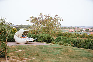 Couple relaxing in a Cabrio sofa overlooking the Belgian countryside
