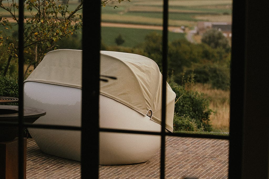 Cabrio with the soft top closed, seen through a window at dusk