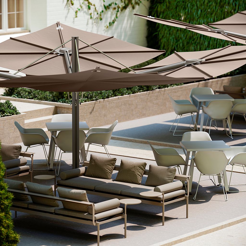 Sol+Luna sofas under a Sensu Quattro shade beside Marina tables and Captain’s Chairs