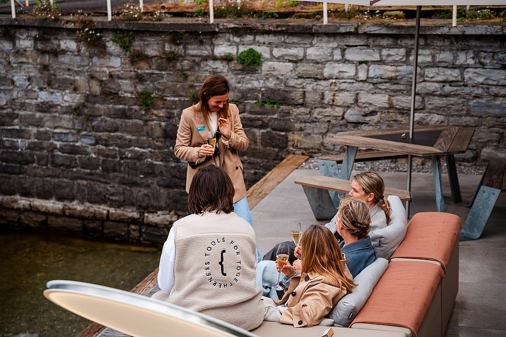 Friends gathered on the Extremis Walrus sofa beside the water at Lake Como
