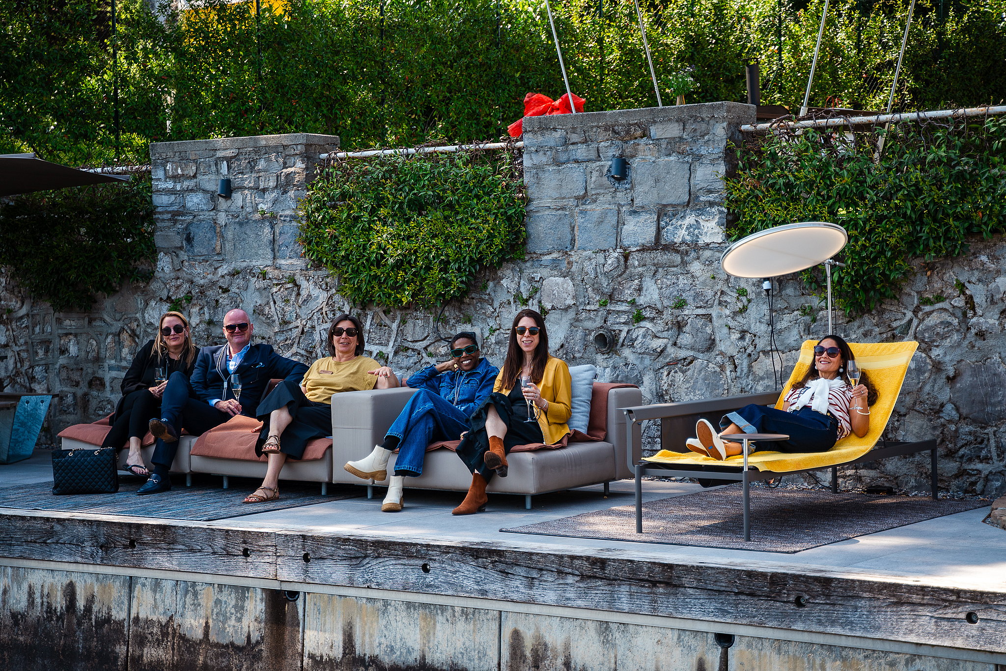 Evening gathering on Extremis Walrus and Sol+Luna furniture along Lake Como