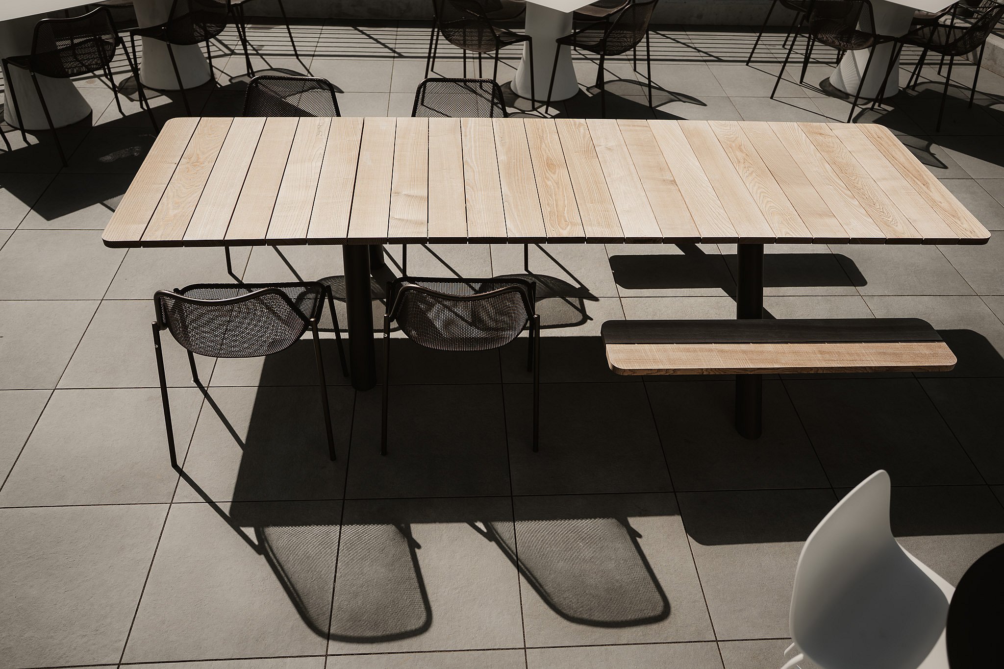Extremis Panigiri outdoor dining tables lined up on the terrace at Acrisure Amphitheater