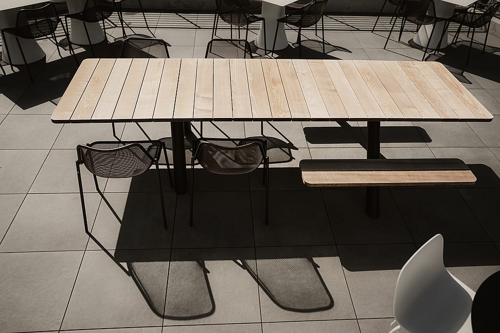 Extremis Panigiri outdoor dining tables lined up on the terrace at Acrisure Amphitheater