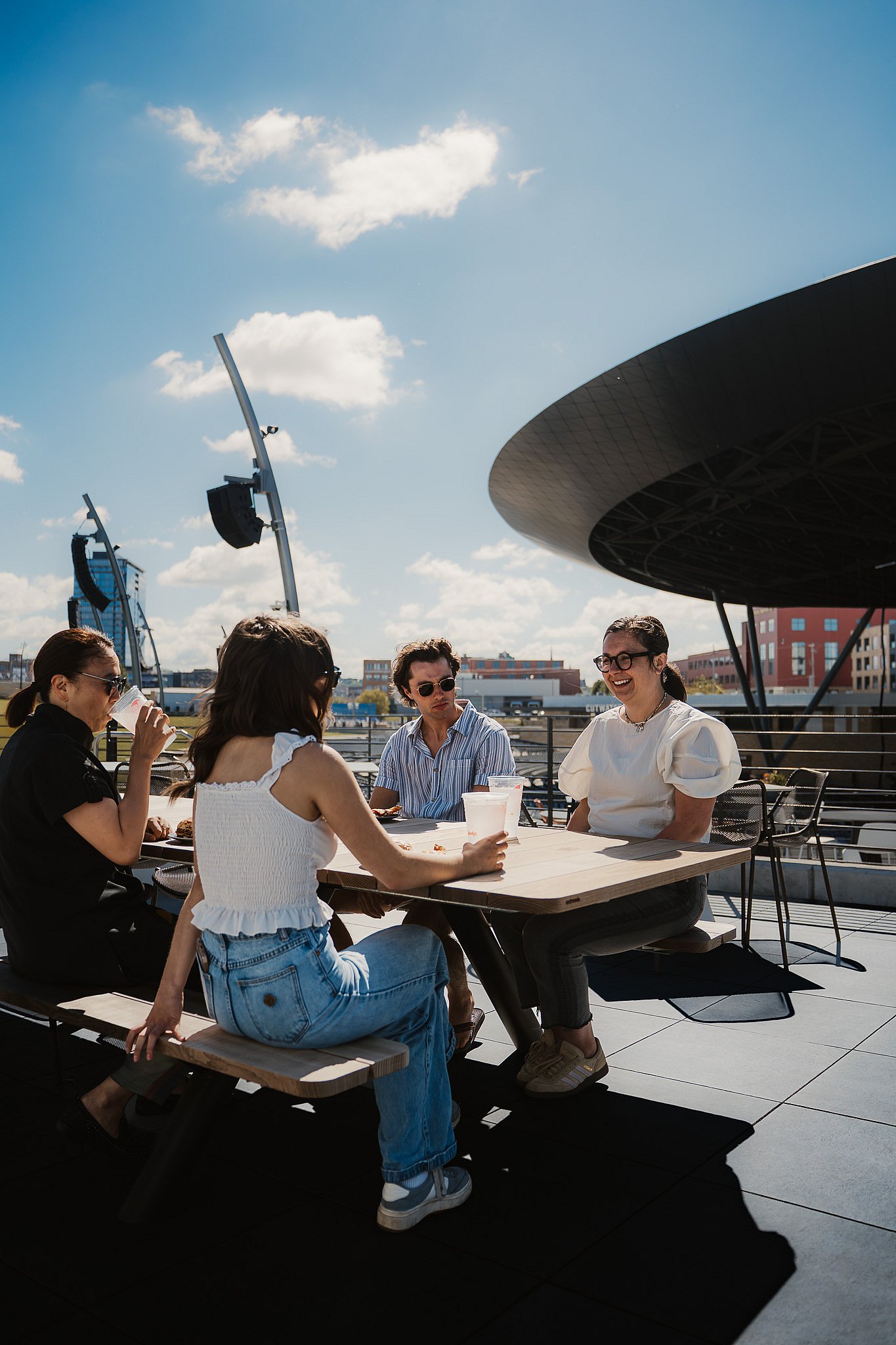 Group of guests eating together at an Extremis Panigiri outdoor dining table